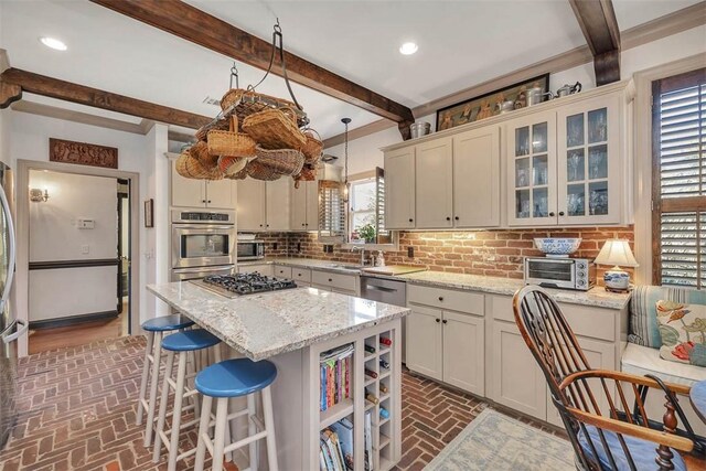 113 Cabretta Island Cir, Brunswick, GA 31520 - kitchen with brick floor, stainless steel appliances, decorative backsplash, glass insert cabinets, and a center island