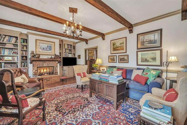 113 Cabretta Island Cir, Brunswick, GA 31520 - living room with wood finished floors, an inviting chandelier, beam ceiling, a fireplace, and ornamental molding