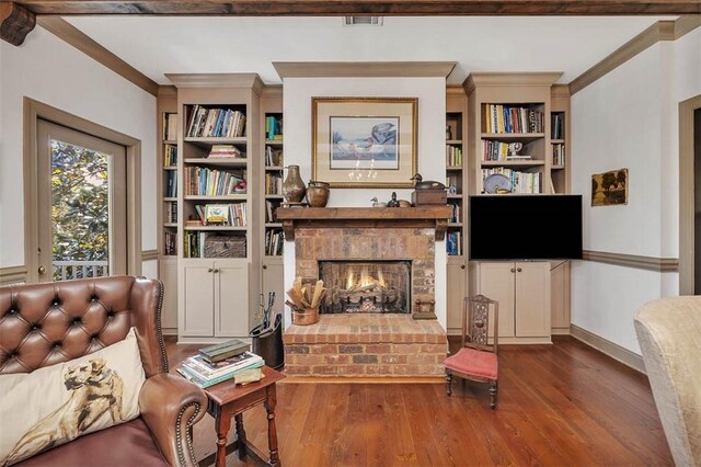 113 Cabretta Island Cir, Brunswick, GA 31520 - living room featuring visible vents, a brick fireplace, crown molding, and wood finished floors