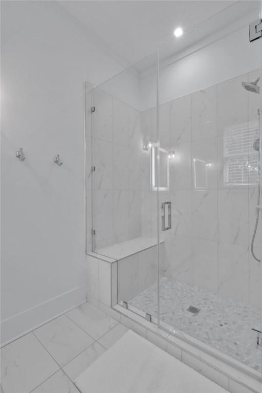 bathroom featuring a shower with door