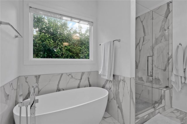 bathroom with separate shower and tub and a wealth of natural light