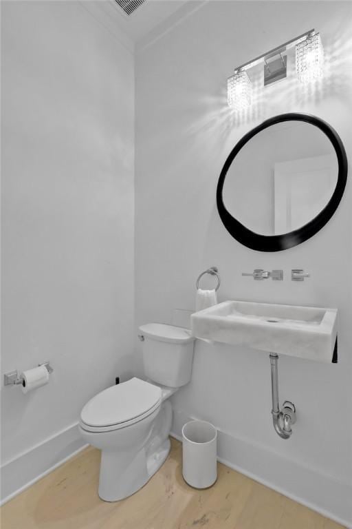 bathroom featuring toilet and wood-type flooring