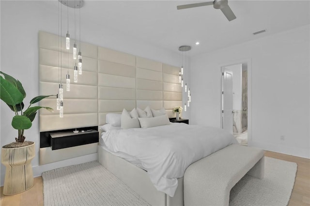 bedroom with ceiling fan and light hardwood / wood-style flooring