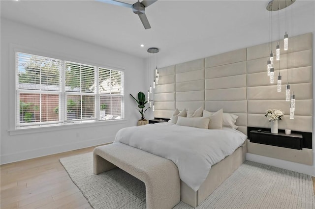 bedroom featuring light wood-type flooring and ceiling fan