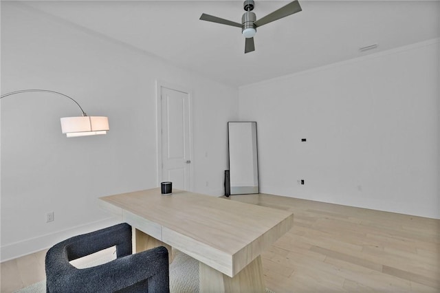 home office featuring ceiling fan, ornamental molding, and light hardwood / wood-style flooring