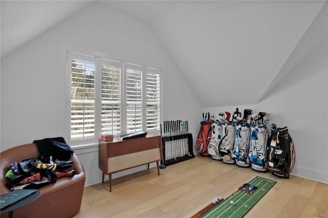 bonus room with vaulted ceiling and light wood-type flooring