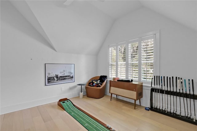 living area featuring wood-type flooring and vaulted ceiling