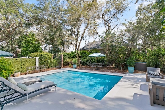 view of swimming pool with a patio, outdoor dining area, a fenced in pool, and fence