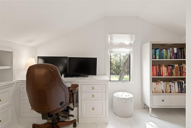 office space with built in features and lofted ceiling