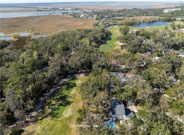 birds eye view of property with a view of trees and a water view