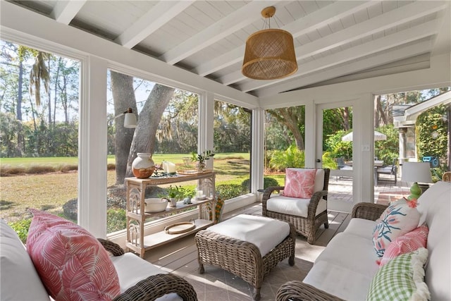 sunroom featuring vaulted ceiling with beams