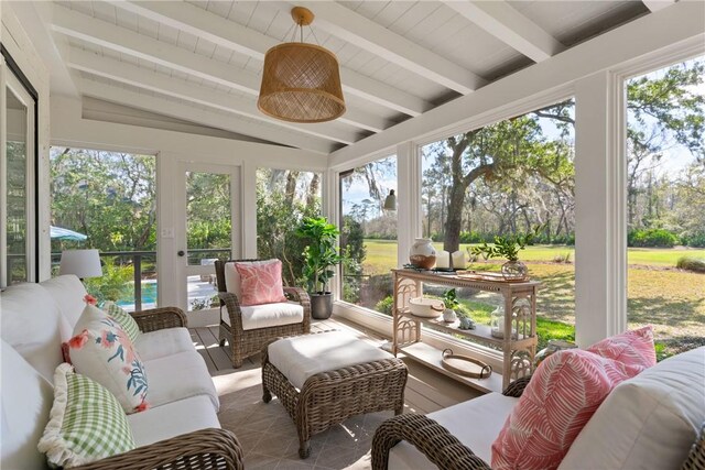 sunroom / solarium with vaulted ceiling with beams