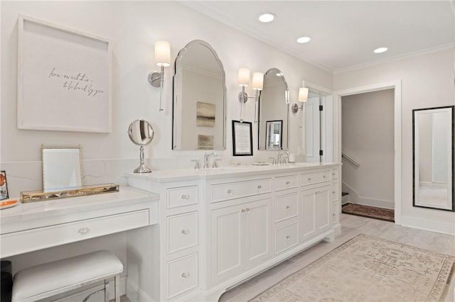 bathroom featuring double vanity, recessed lighting, wood finished floors, and ornamental molding