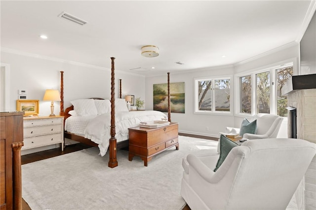 bedroom with visible vents, recessed lighting, a fireplace, and crown molding