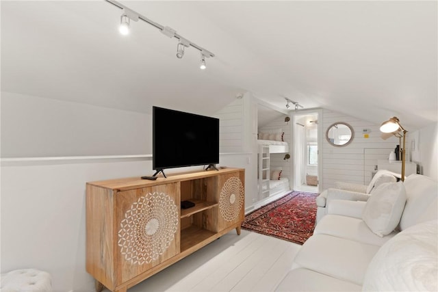 living area with lofted ceiling and wood finished floors