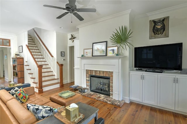 109 Mooring Ln, Saint Marys, GA 31558 - living area featuring stairs, a ceiling fan, wood finished floors, ornamental molding, and a fireplace