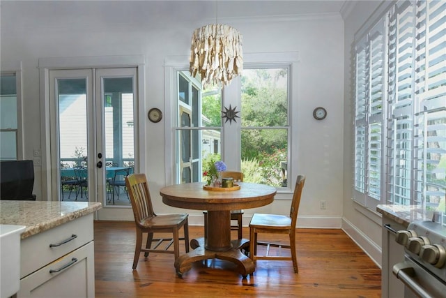 109 Mooring Ln, Saint Marys, GA 31558 - dining room featuring french doors, wood finished floors, a chandelier, and ornamental molding