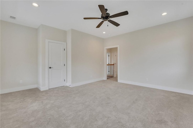 carpeted spare room featuring ceiling fan