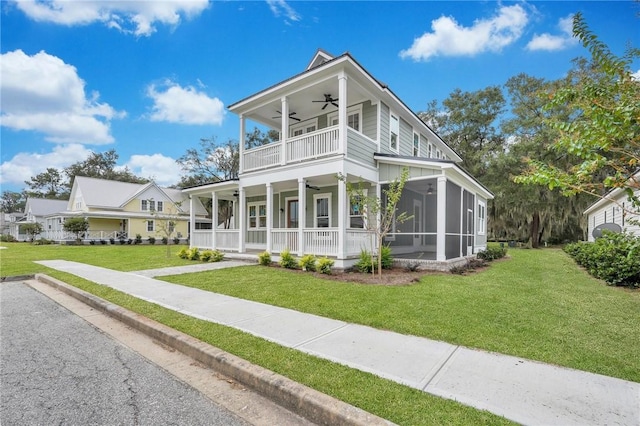 view of front facade with a front yard, a balcony, covered porch, and a sunroom