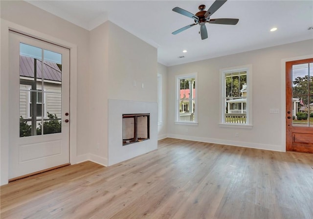 unfurnished living room with light wood-type flooring, plenty of natural light, and ceiling fan