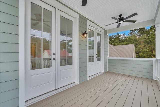 wooden terrace featuring ceiling fan, covered porch, and french doors