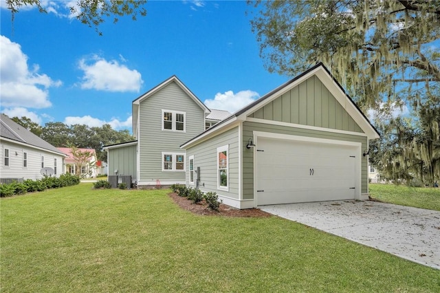 exterior space with a lawn, central AC unit, and a garage