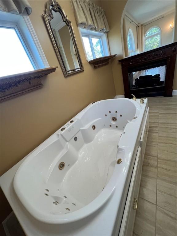 bathroom featuring tile patterned flooring and a tub