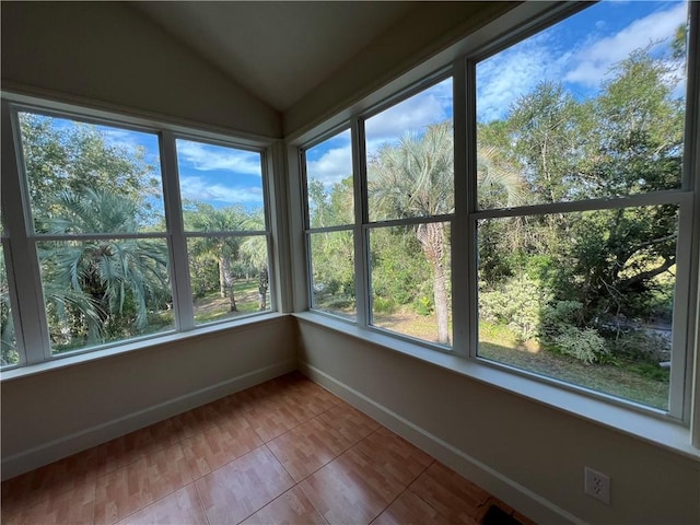 unfurnished sunroom featuring lofted ceiling