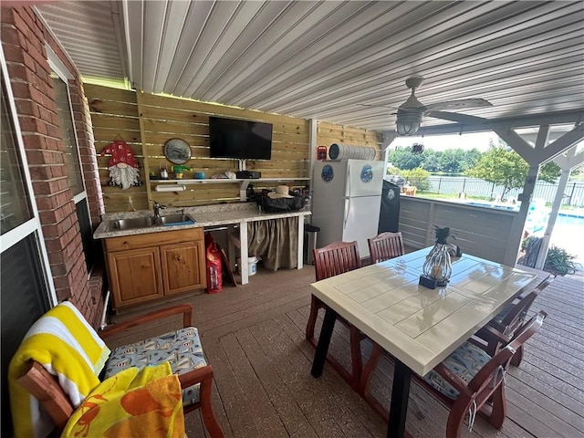 wooden terrace featuring ceiling fan and sink