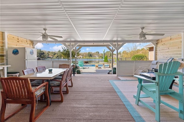 wooden deck featuring ceiling fan and a swimming pool