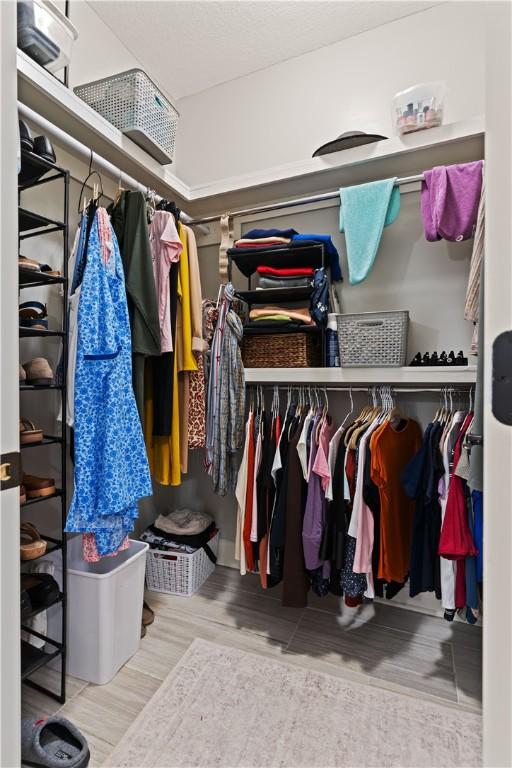 walk in closet with hardwood / wood-style flooring