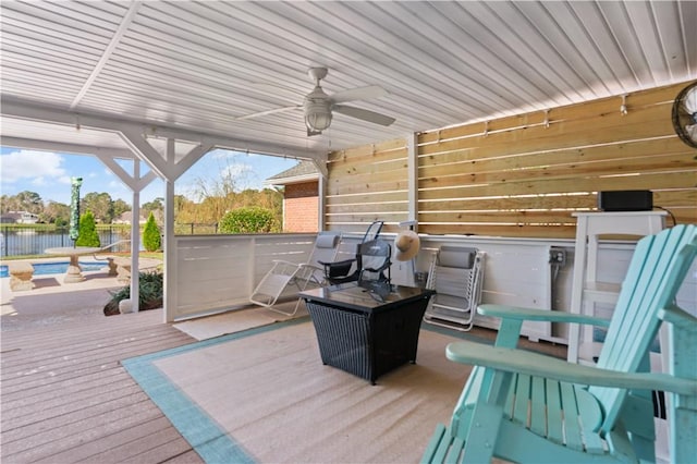 deck featuring ceiling fan and a water view