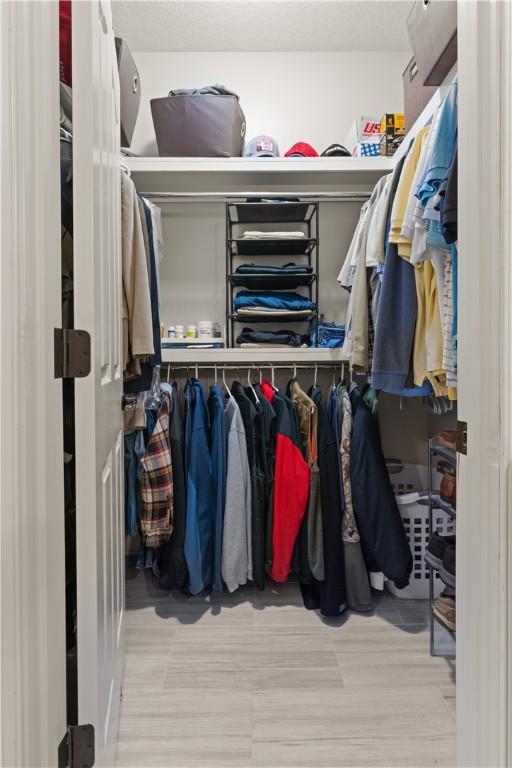 spacious closet featuring light wood-type flooring