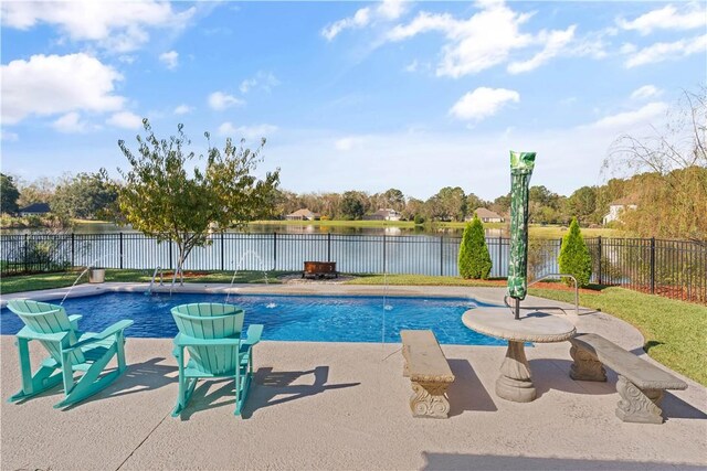 view of swimming pool featuring pool water feature, a water view, and a patio