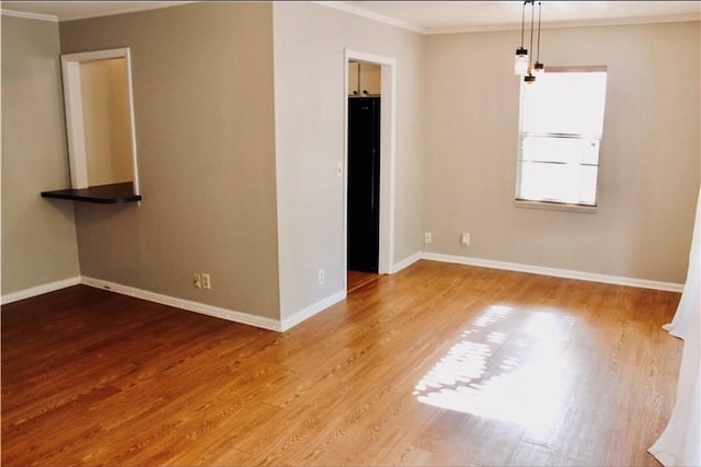 800 Mallery St Unit 90, Saint Simons Island, GA 31522 - spare room featuring ornamental molding, wood finished floors, and baseboards