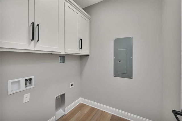 laundry area with cabinets, washer hookup, hookup for an electric dryer, light hardwood / wood-style floors, and electric panel