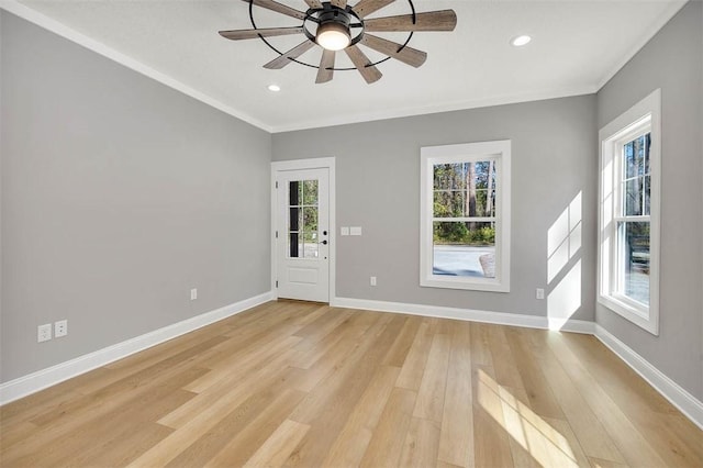 empty room featuring ceiling fan, light hardwood / wood-style floors, and ornamental molding