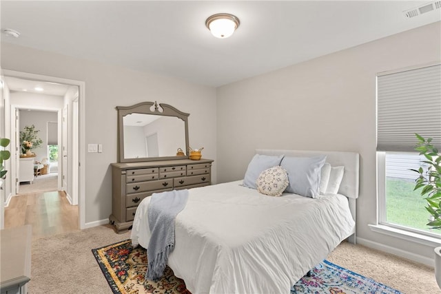 116 Heatherly Way, Brunswick, GA 31523 - bedroom featuring multiple windows, baseboards, and light carpet