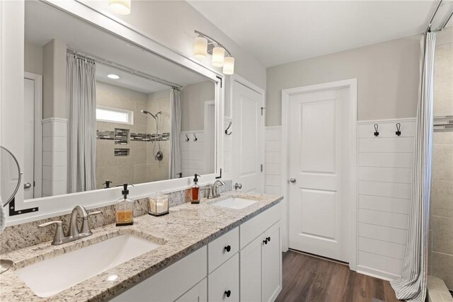 116 Heatherly Way, Brunswick, GA 31523 - full bath with tiled shower, double vanity, wood finished floors, and a wainscoted wall