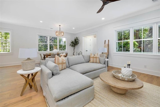 living area with recessed lighting, light wood-type flooring, a ceiling fan, baseboards, and ornamental molding
