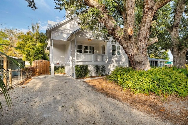 view of front of home with fence, a gate, and covered porch