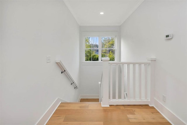 stairway featuring wood finished floors, baseboards, and recessed lighting