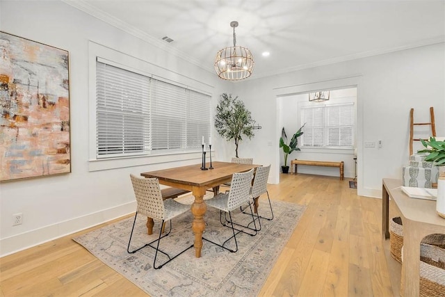 dining space featuring a chandelier, crown molding, light wood-type flooring, recessed lighting, and baseboards