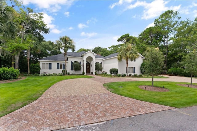 mediterranean / spanish house featuring a front lawn