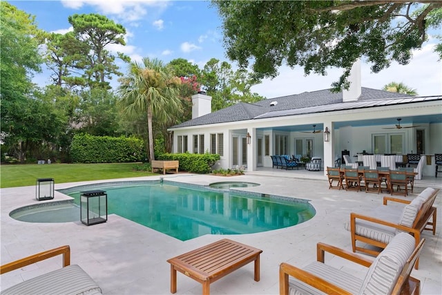 view of pool featuring outdoor lounge area, an in ground hot tub, ceiling fan, and a patio area