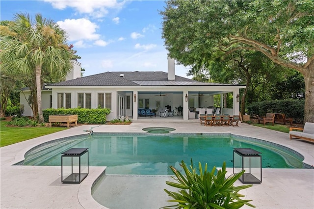 view of swimming pool with a patio area, ceiling fan, and an in ground hot tub