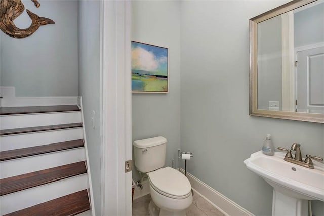 bathroom with tile patterned flooring, toilet, and sink