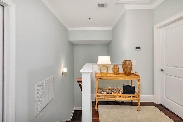 interior space with dark hardwood / wood-style flooring and ornamental molding