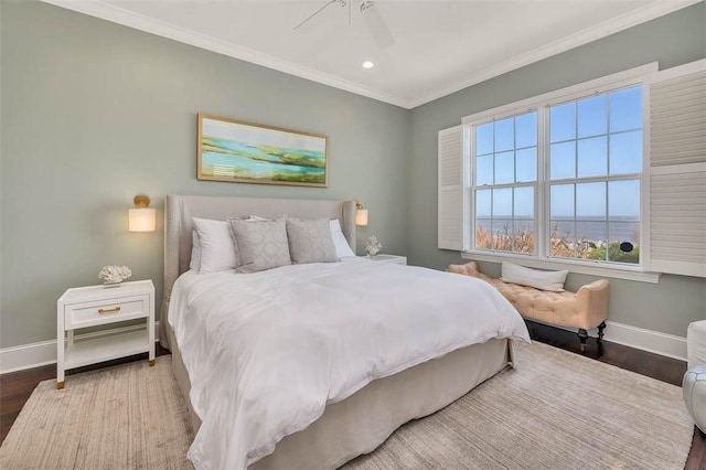 bedroom featuring hardwood / wood-style flooring, ceiling fan, and ornamental molding