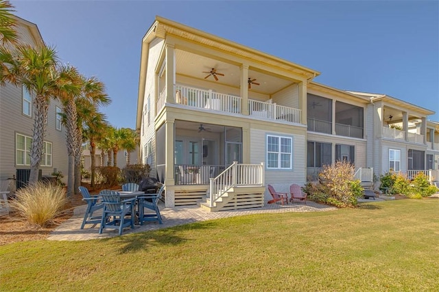 back of property featuring a lawn, ceiling fan, a sunroom, a balcony, and a patio area